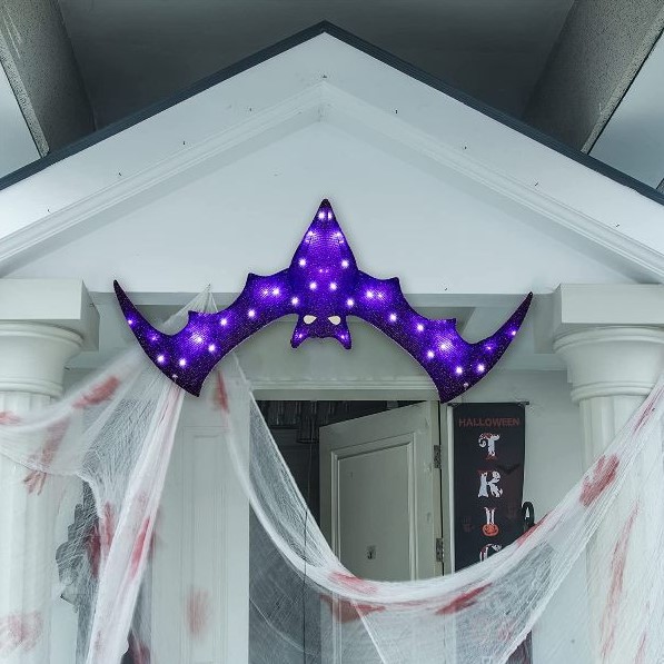 a bold and pretty purple bat marquee light over the entrace instead of a wreath or another Halloween door decoration