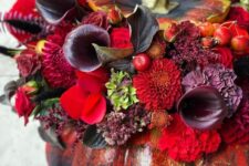 39 a sophisticated black Halloween pumpkin done with red, burgundy, deep purple blooms, foliage and berries