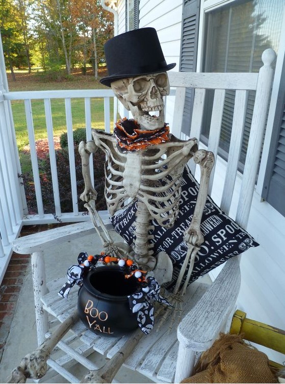 a skeleton in a top hat serving some sweets and candies in a cauldron is a cool idea for Halloween and creative decor