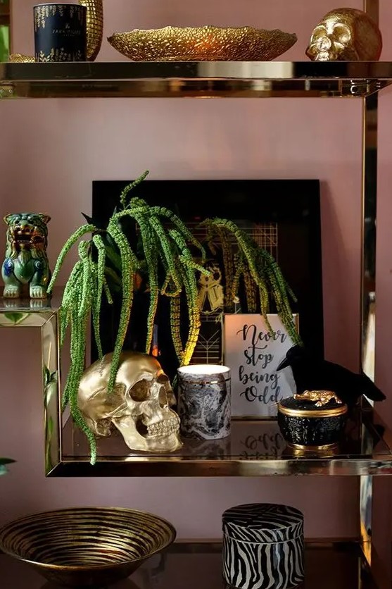 refined and glam Halloween styling with an artwork, a crow, gold skulls and some candles