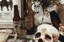 50 vintage Halloween decor with a patterned skull, poison bottles, greenery, vintage signs and artworks is easy to recreate yourself
