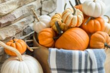 02 a basket with white and orange pumpkins and a blue plaid blanket is a lovely decoration for fall and Thanksgiving