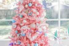 04 a bright candy-colored Christmas tree with bold blue ornaments, ice cream and popsicle ornaments and a candy topper