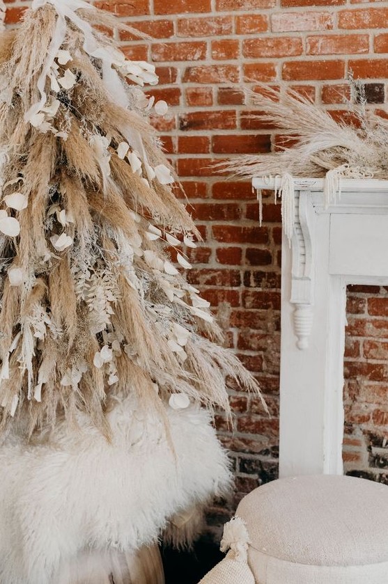 a creative boho Christmas tree of pampas grass and snowy branches, petals and ribbons and matching mantel decor