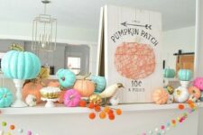 05 a colorful fall or Thanksgiving mantel with bright pompoms, bold pumpkins, a plaque sign and white birds