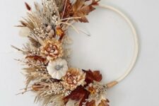 06 a boho Thanksgiving wreath of an embrodiery hoop, with dried grasses, faux blooms and leaves, some twigs and berries