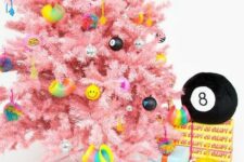 06 a bright pink Christmas tree with funny and colorful modern ornaments including emoji ones ooks fresh and very bold