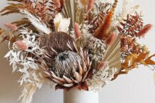 07 a bright boho Thanksgiving centerpiece with dried leaves, bunny tails and various blooms and fronds