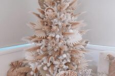 09 a boho neutral Christmas tree with pampas grass and dried fronds, white and neutral ornaments, some wooden beads