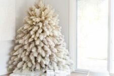 11 a white pampas grass Christmas tree with no decor and only lights is a fntastic solution for a boho feel in the space