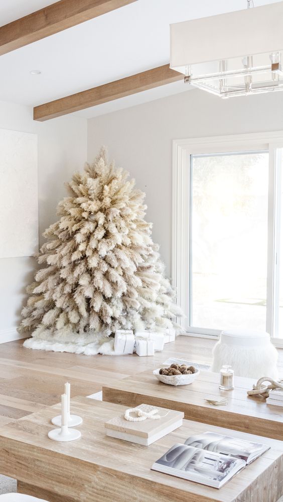 a white pampas grass Christmas tree with no decor and only lights is a fntastic solution for a boho feel in the space