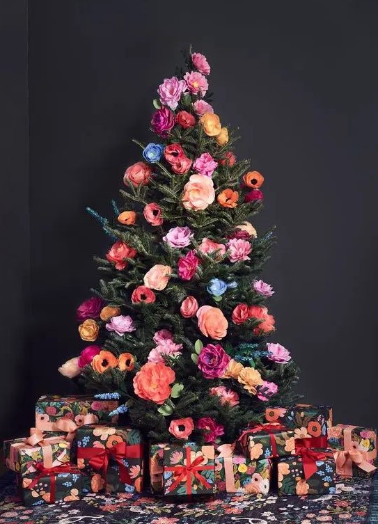 a beautiful and colorful Christmas tree decorated with faux blooms all the shades possible is a cool out of the box idea