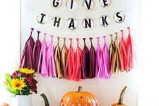 13 a pumpkin stand with colorful tassels and a banner, bright polka dot pumpkins and bold blooms is pure fun