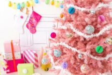 14 a pastel pink Christmas tree with colorful paper and glass Christmas ornaments and white garlands is a colorful modern solution