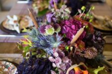 15 a refined and bold Thanksgiving centerpiece of purple, orange and fuchsia blooms, greenery, thistles and some foliage