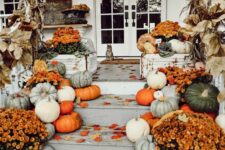 15 rustic and organic Thanksgiving porch decor with white, light green and orange pumpkins, orange blooms and cron husks