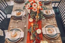 16 a beautiful bright Thanksgiving tablescape with an orange table runner and candles, white pumpkins and orange and white flowers