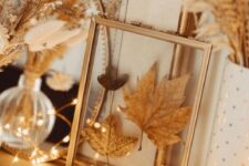 16 lovely boho Thanksgiving decor with little pumpkins, lights, grasses and wheat and pressed leaves in a frame