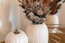 a lovely fall arrangement in white pumpkins