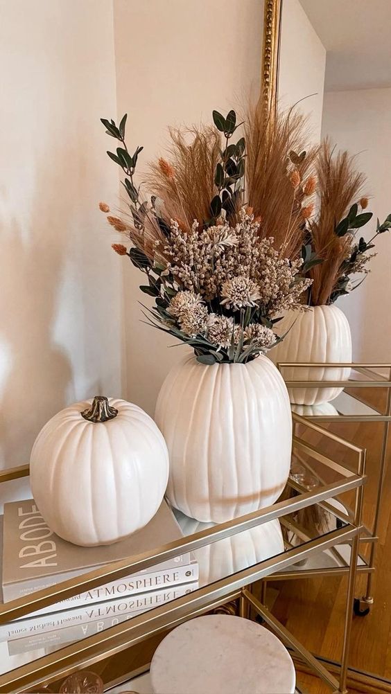 lovely fall or Thanksgiving decor with a boho feel, white pumpkins and various grasses, bunny tails and greenery plus dried blooms