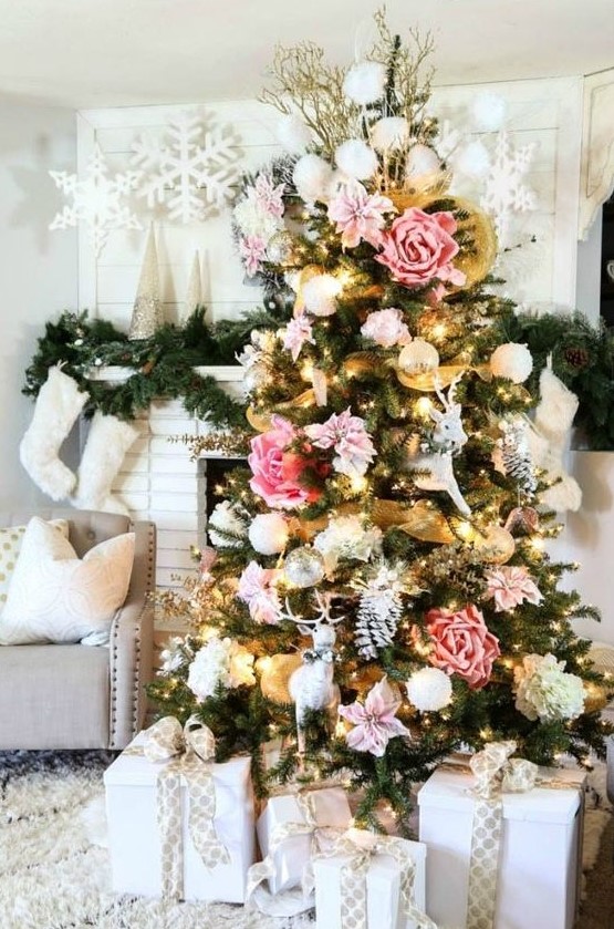 a Christmas tree with blush, pink and white blooms of a large size, gold mesh ribbon is a bold and catchy idea for a boho space