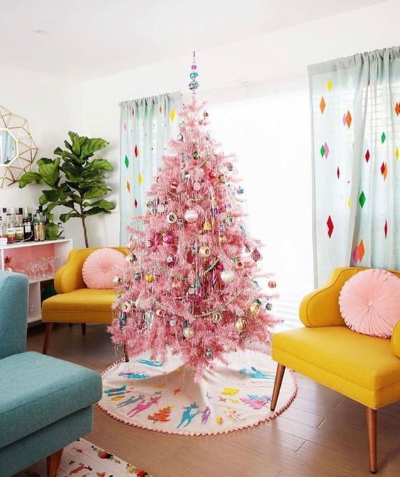 a pink Christmas tree decorated with vintage ornaments and beads, a bright tree skirt with images for a vintage space