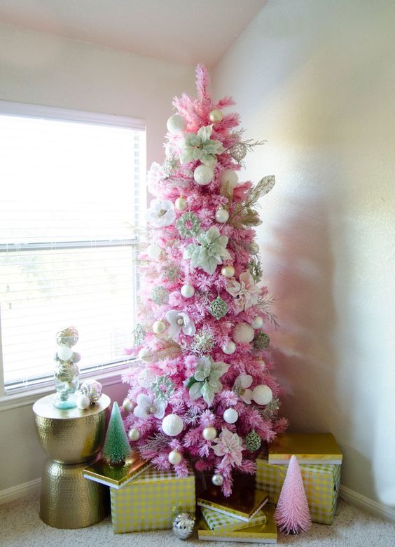 a pink Christmas tree decorated with white and gold ornaents, with fabric blooms is a stylish idea for a glam space