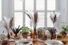 24 a boho Thanksgiving tablescape with large plates and white pumpkins, folk sharpie pumpkins, pampas grass and potted cacti