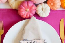 26 a bright Thanksgiving tablescape with a hot pink tablecloth, bold pumpkins and bold blooms, dip dyed napkins