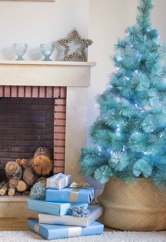 a beautiful modern turquoise Christmas tree with blue lights in a basket is a gorgeous solution, it requires no ornaments as it stands out itself