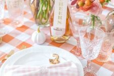 31 a cool blush and orange Thanksgiving tablscape with orange and pink blooms, white pumpkins and gold cutlery