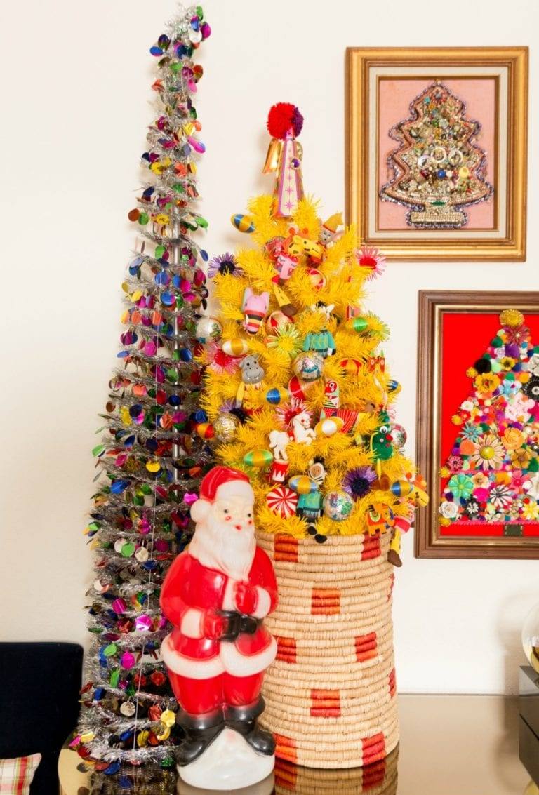 a yellow Christmas tree decorated with bold vintage ornaments and placed into a basket is a fun and bold idea to rock