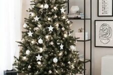 35 a Scandinavian Christmas tree decorated with white ball and star ornaments, metallic ornaments plus lights in a basket