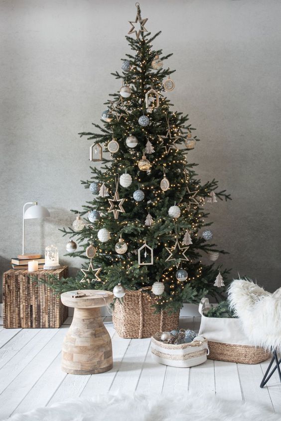 a Scandinavian Christmas tree with lights, wooden ornaments and some traditional baubles is a stylish idea