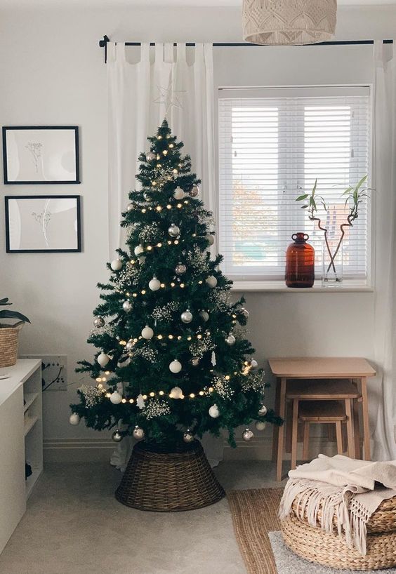 a Scandinavian Christmas tree with white and silver ornaments, snowballs, tree and snowflake-shaped ornaments