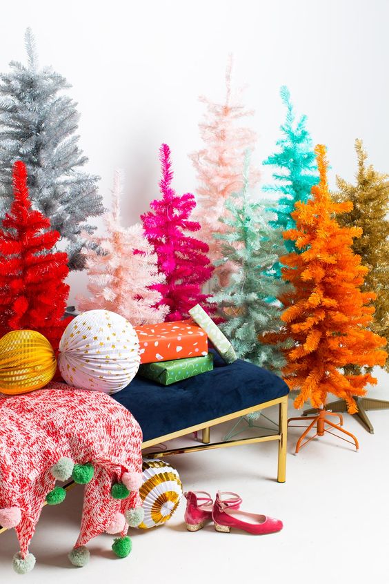 an arrangement of Christmas trees of various colors - mint, turquoise, pink, hot pink, orange, red and silver with no decor