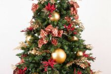 50 a bold red and gold Christmas tree with bows, gilded foliage, large gold ornaments