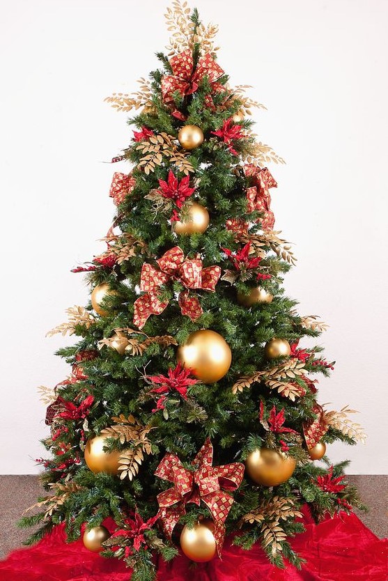 a bold red and gold Christmas tree with bows, gilded foliage, large gold ornaments