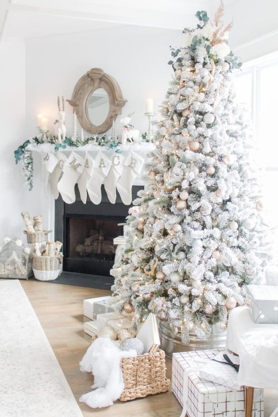a magical flocked Christmas tree with gold, white and silver ornaments, pinecones, greenery, lights and grasses is amazing
