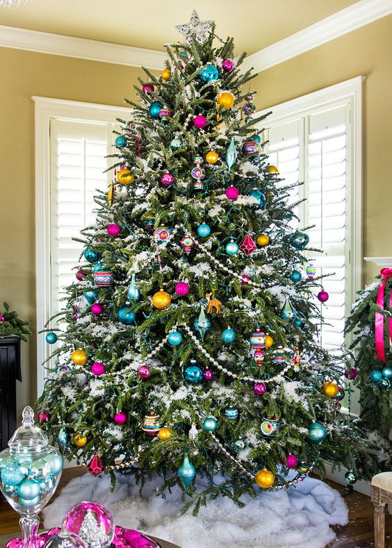 a vintage-inspired Christmas tree with beads, colorful ornaments of various shapes and a star on top