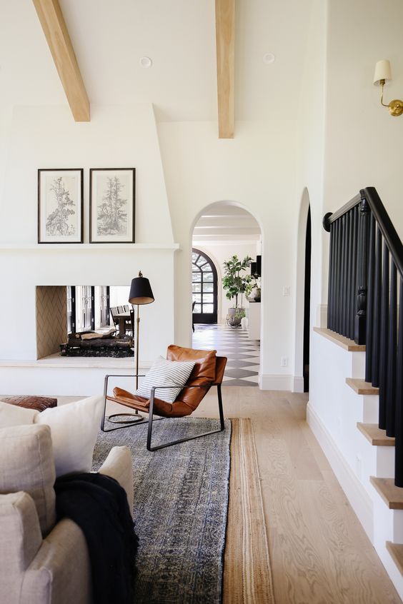 a beautiful Spanish farmhouse space with a lrge double-sided fireplace that lights up and warms up both the dining and living room