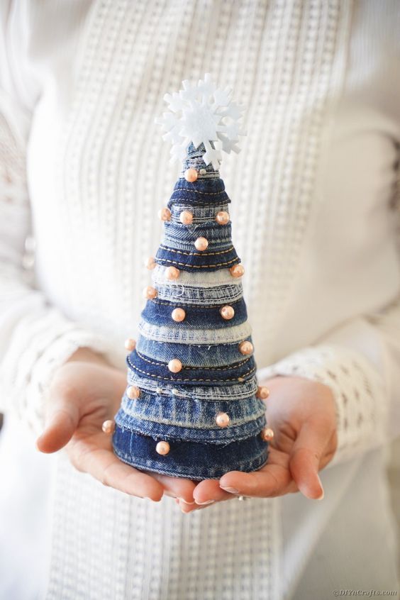 a bleached and navy denim cone Christmas tree decorated with pearls and topped with a felt snowflake