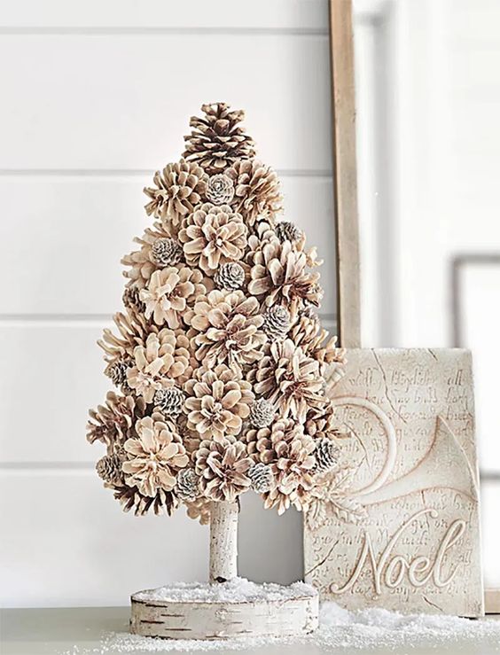 a bleached pinecone Christmas tree on a stand is a very cool and cozy farmhouse or woodland decor idea for winter