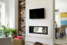 a built-in double-sided fireplace gives interest and a cozy feel to both the living room and the dining zone