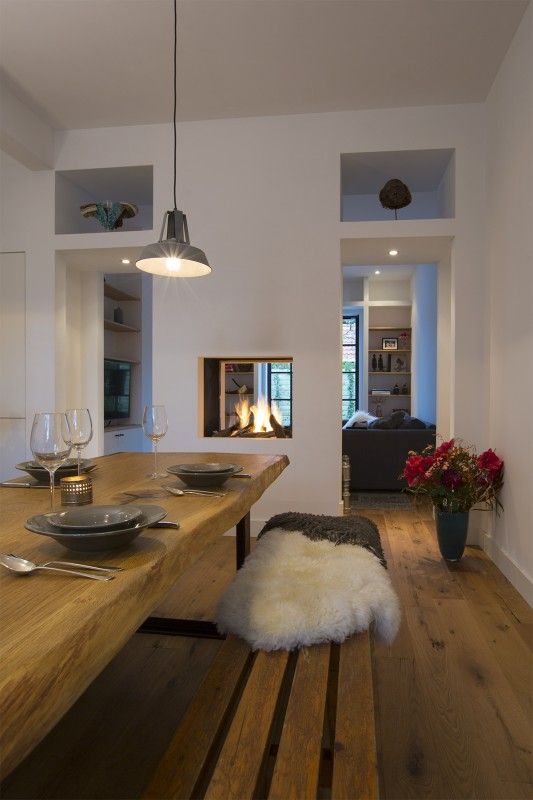a built in double sided fireplace gives light and warmth to the dining and living room and separates them