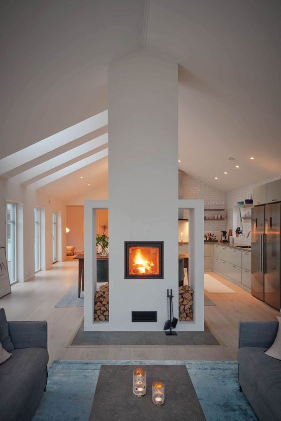 a built-in fireplace with firewood storage gives a lovely touch to both the living room and the kitchen