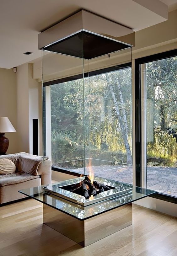 a clear glass fireplace like this one can be seen from all the points, which makes it a perfect solution for an open layout