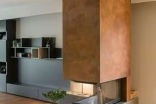 a contemporary double-sided  fireplace with a concrete base, a metal hood and a glass cover looks contrasting and very bold