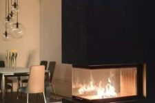 a contemporary double-sided fireplace with a sleek black tile top and a light-colored stone base is a bold contrasting idea to rock