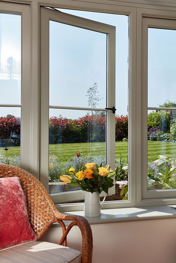 a country space with a large wood frame casement window and a gorgeous view of the garden just wows